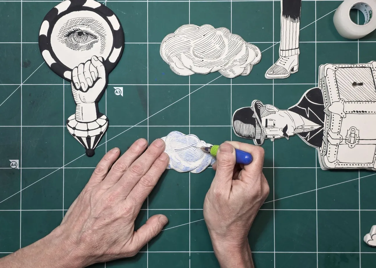 Drawing fine lines on a ceramic piece with the hand-made underglaze applicator